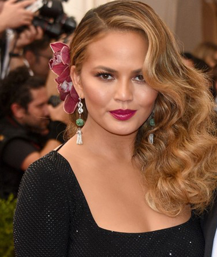 Chrissie Teigen wears tassel earrings at the 2015 Met Gala